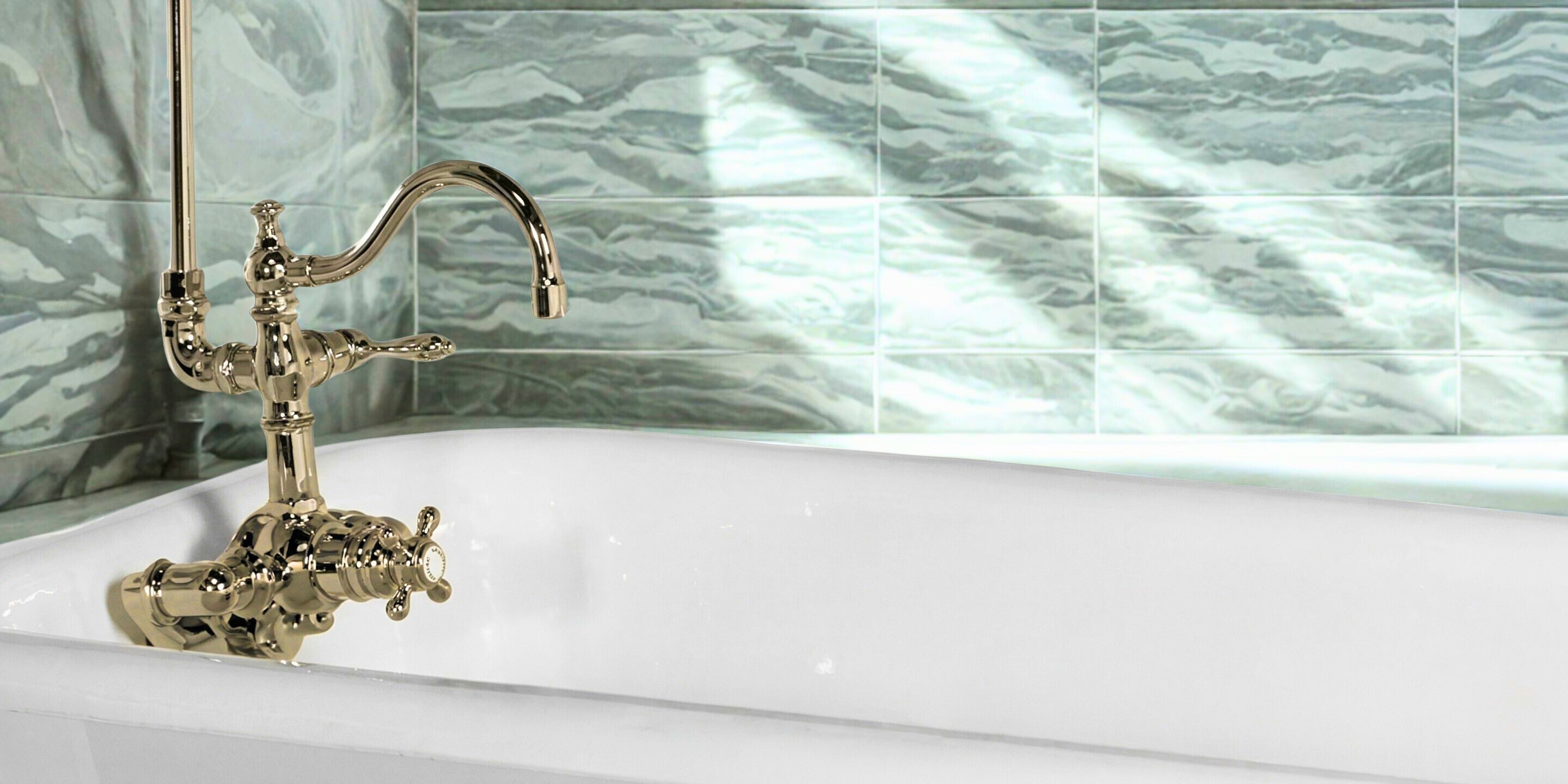A Brass vintage style faucet on a clawfoot tub  